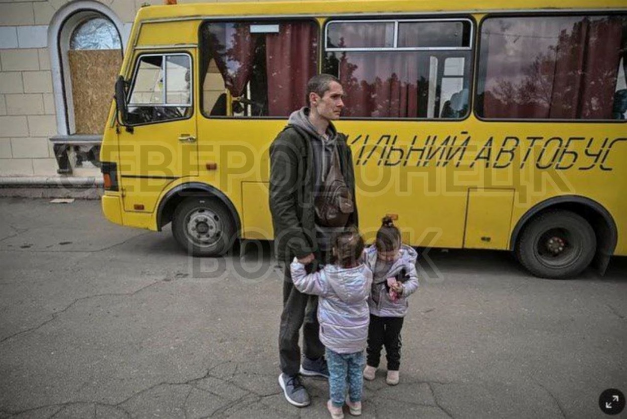 Dmytro, Marharyta, and Myroslava near the bus in Lysychansk