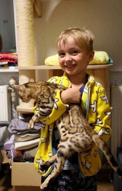 Marianna’s younger son holding a cat. 