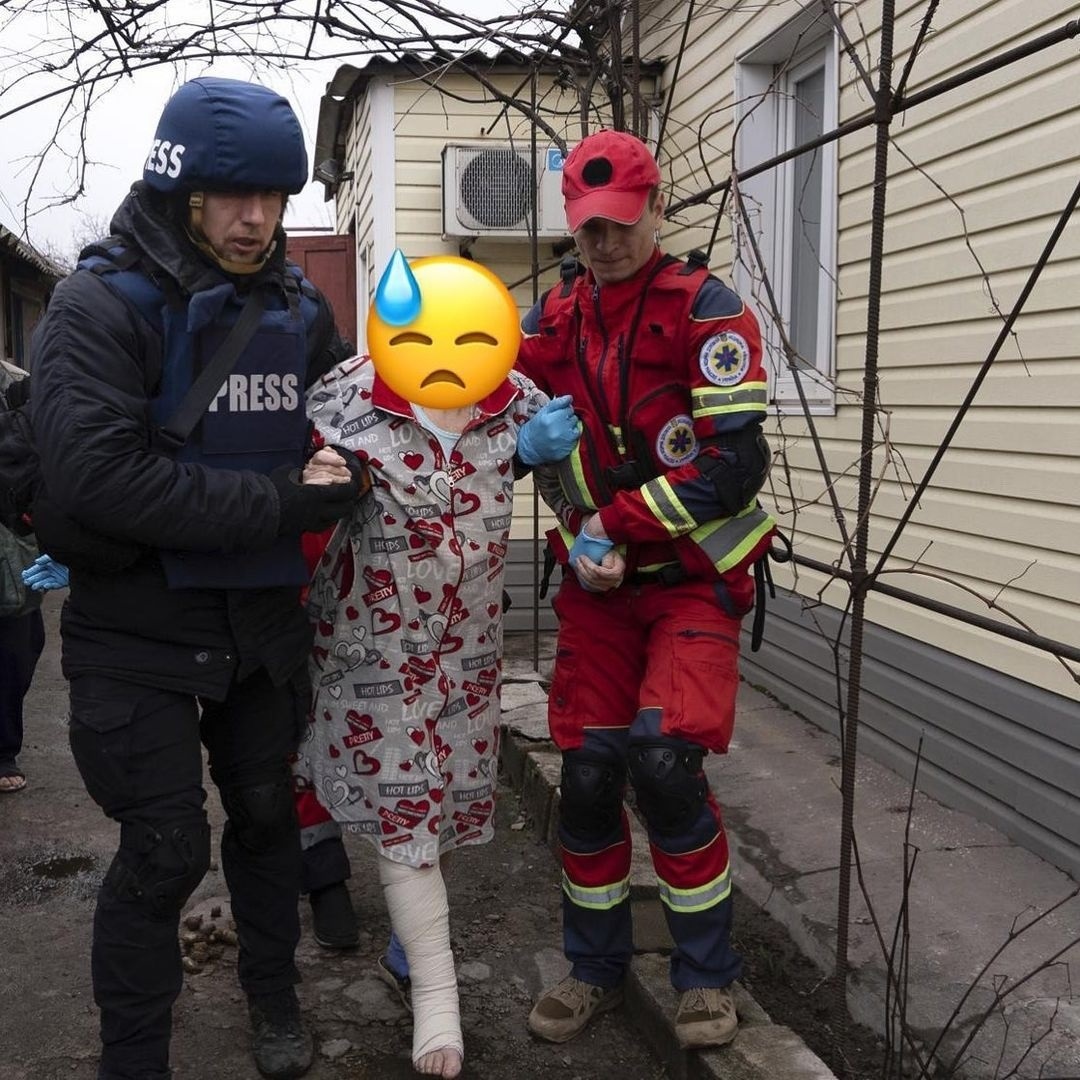 Serhiy being assisted by a photo reporter, Yevhen Malolietka